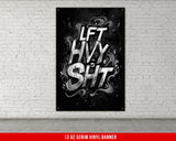 a black and white poster hanging on a brick wall