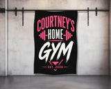 Black gym towel with pink text "COURTNEY'S HOME GYM EST. 2026".