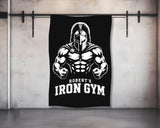 Robert's Iron Gym Spartan helmet logo on black banner.