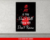 A white, checkered-patterned fabric is rolled up and secured with a gold ring, which is fastened with a gold ring.