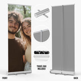 a couple posing for a photo on a roller banner. The banner is gray and includes a travel bag included in the purchase.