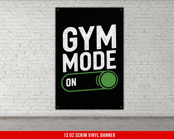 a gym poster hanging on a white brick wall