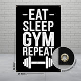 Black banner with white text "EAT GYM REPEAT" and reinforced metal grommets.