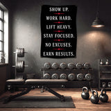 Black banner with motivational fitness quotes on a gym wall.
