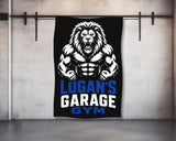 Black gym banner with muscular lion logo and text "LOGAN'S GARAGE GYM".