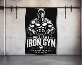 Black flag with "WILLIAMS IRON GYM TRAIN HARD EST 2026" and Spartan warrior graphic.