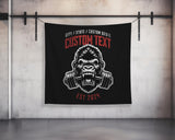 a wall hanging on a wall with a gorilla head and barbells