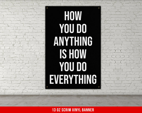 a black and white poster hanging on a brick wall