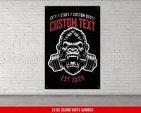 a gorilla with a barbell in his mouth on a brick wall