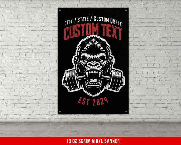 a gorilla with a barbell in his mouth on a brick wall