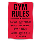 Red sign with black text listing gym rules: Respect the equipment, people, keep it clean, support each other, stay humble.