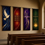 a row of four religious banners hanging on a wall inside a church.