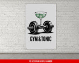 a gym and tonic poster hanging on a brick wall