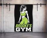 Brooke's Gym logo with woman holding dumbbell on black background.