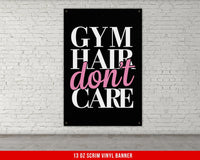 a gym sign hanging on a white brick wall