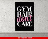 a gym sign hanging on a white brick wall