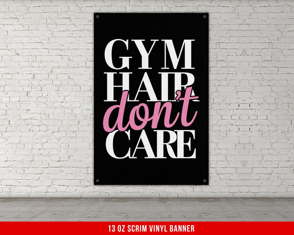 a gym sign hanging on a white brick wall
