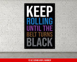 A white, checkered-patterned fabric is rolled up and secured with a gold ring, which is fastened with a gold ring.