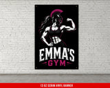 Spartan woman flexing in front of EMMA'S GYM banner.