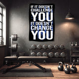 Motivational gym banner with text "IF IT DOESN'T CHALLENGE YOU IT DOESN'T CHANGE YOU".
