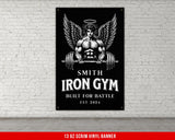a gym sign hanging on a white brick wall