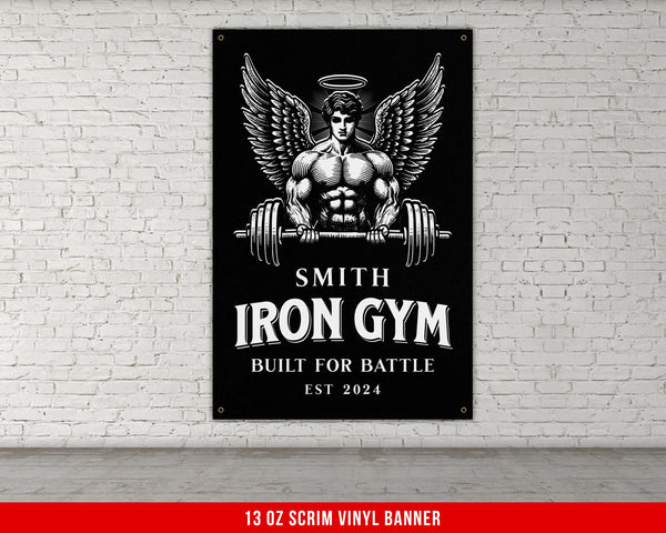 a gym sign hanging on a white brick wall