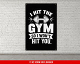 a gym poster hanging on a white brick wall