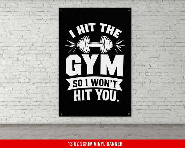 a gym poster hanging on a white brick wall