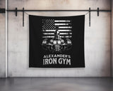 a black wall hanging with a iron gym sign