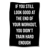 Black banner with white text reading "If you still look good at the end of your workout, you didn't train hard enough."