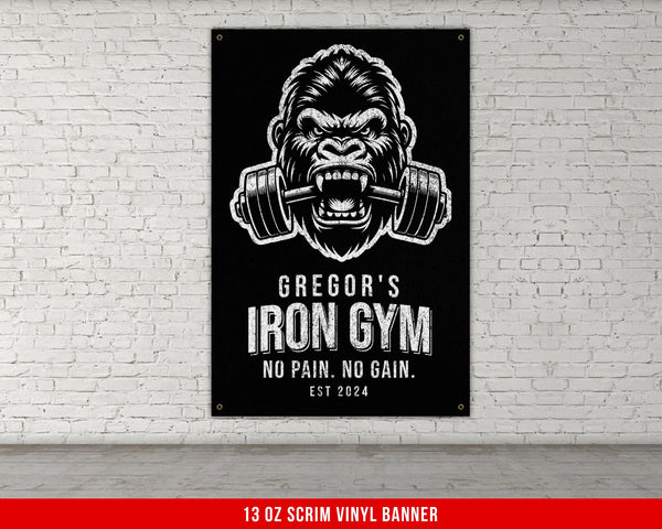 a gorilla with a barbell in his mouth on a brick wall