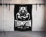 Black and white towel with Thompson Home Gym logo featuring a bear.