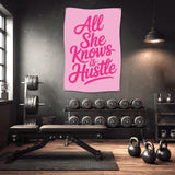 Pink banner in gym reads "All She Knows is Hustle".