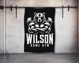 Black and white gym towel with muscular bear and "WILSON HOME GYM" text.