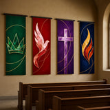 a row of four colorful banners hanging on a wall inside a church, each depicting a different religious symbol or icon.