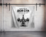 a towel hanging on a wall with a picture of a man holding a barbell