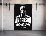 Black towel with white Spartan helmet logo and "ANDERSON HOME GYM" text.
