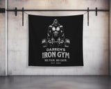 a black wall hanging on a wall with a picture of a man lifting a bar