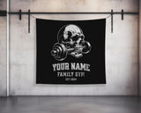 a black banner with a skull holding a barbell