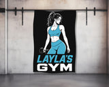 Black towel with "LAYLA'S GYM" text and woman holding dumbbell logo.