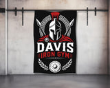 Davis Iron Gym Spartan helmet and spears logo on a black banner.