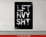 a black and white poster hanging on a brick wall