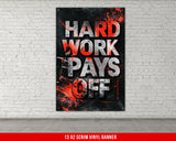 a red and black poster hanging on a white brick wall
