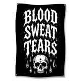 Black banner with "BLOOD SWEAT TEARS" in white dripping letters above a skull.