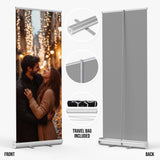 a couple embracing in front of a backdrop with a blurred background of lights.